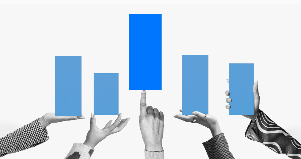 Hands holding vertical bar graphs of various lengths for comparison