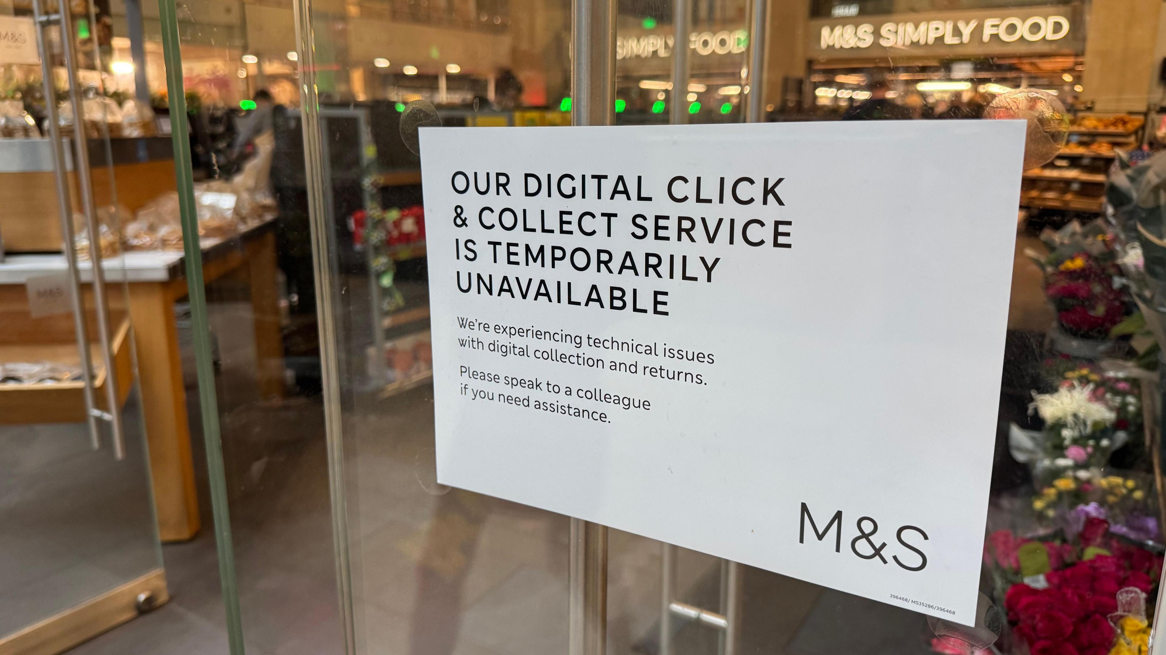 A white sign on the door of a Marks and Spencer branch in London reads 