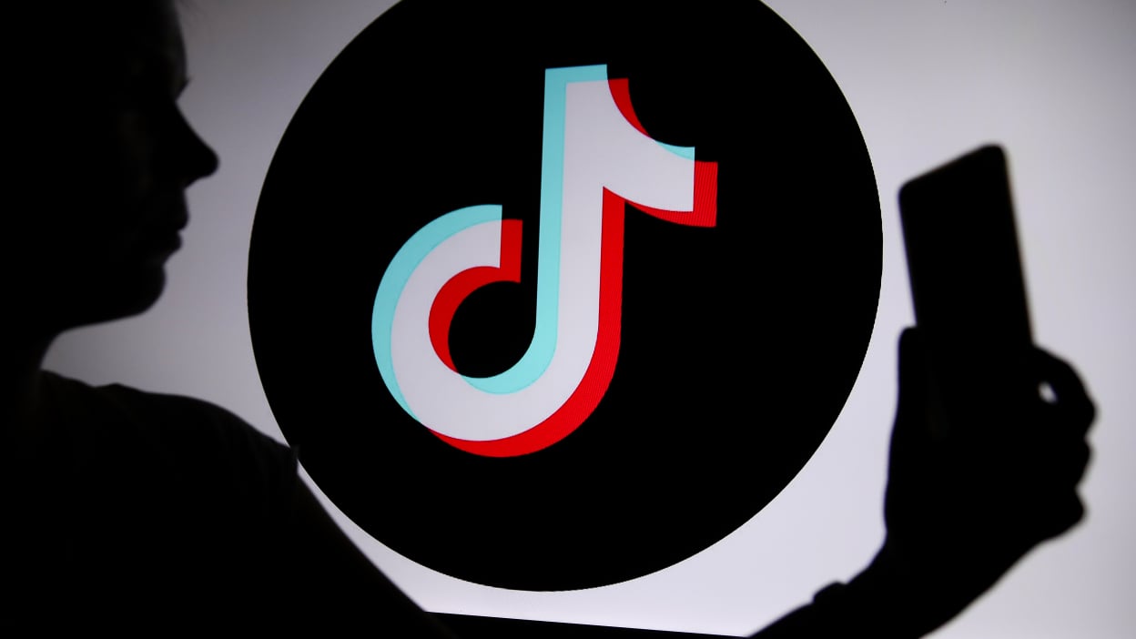 The TikTok logo with a person holding a phone in their hand is seen in Knurow, Poland, on April 20, 2025.