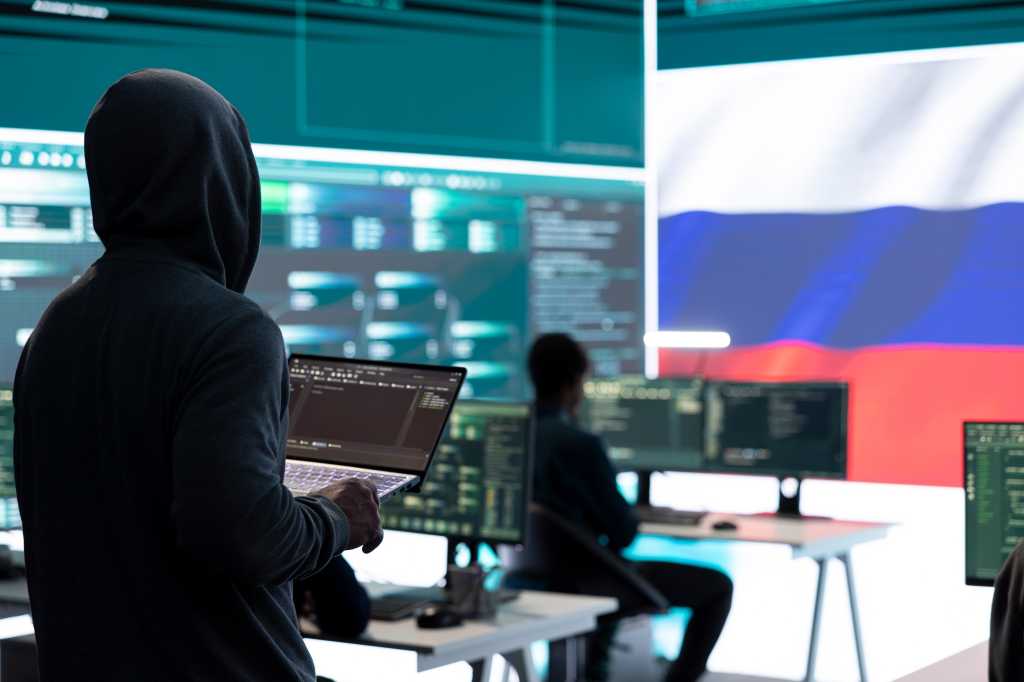 Dishonest person in a Russian cyber security room hacking systems