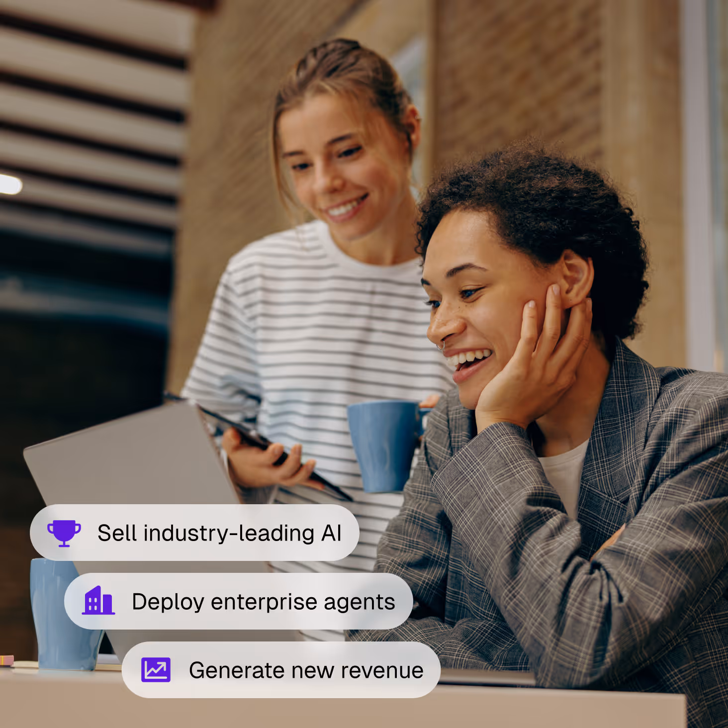 Two people smiling and looking at a laptop screen